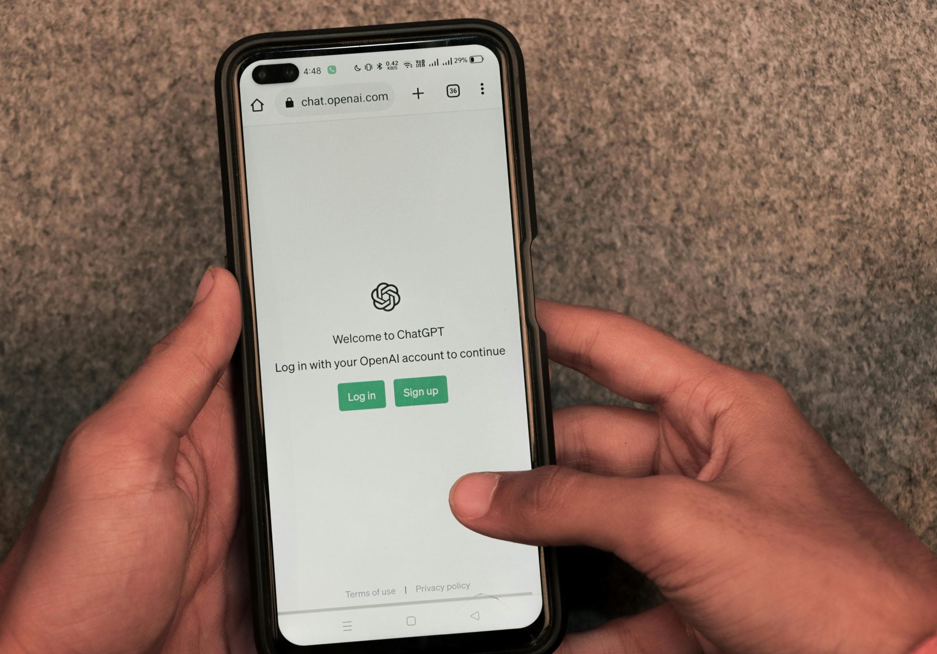 User holding a smartphone displaying an AI assistant interface, representing AI customer discovery and modern search behavior