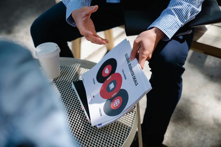 A professional analyzing digital data interfaces to compare mentions and citations for AI visibility for businesses at JAR Consulting Group.