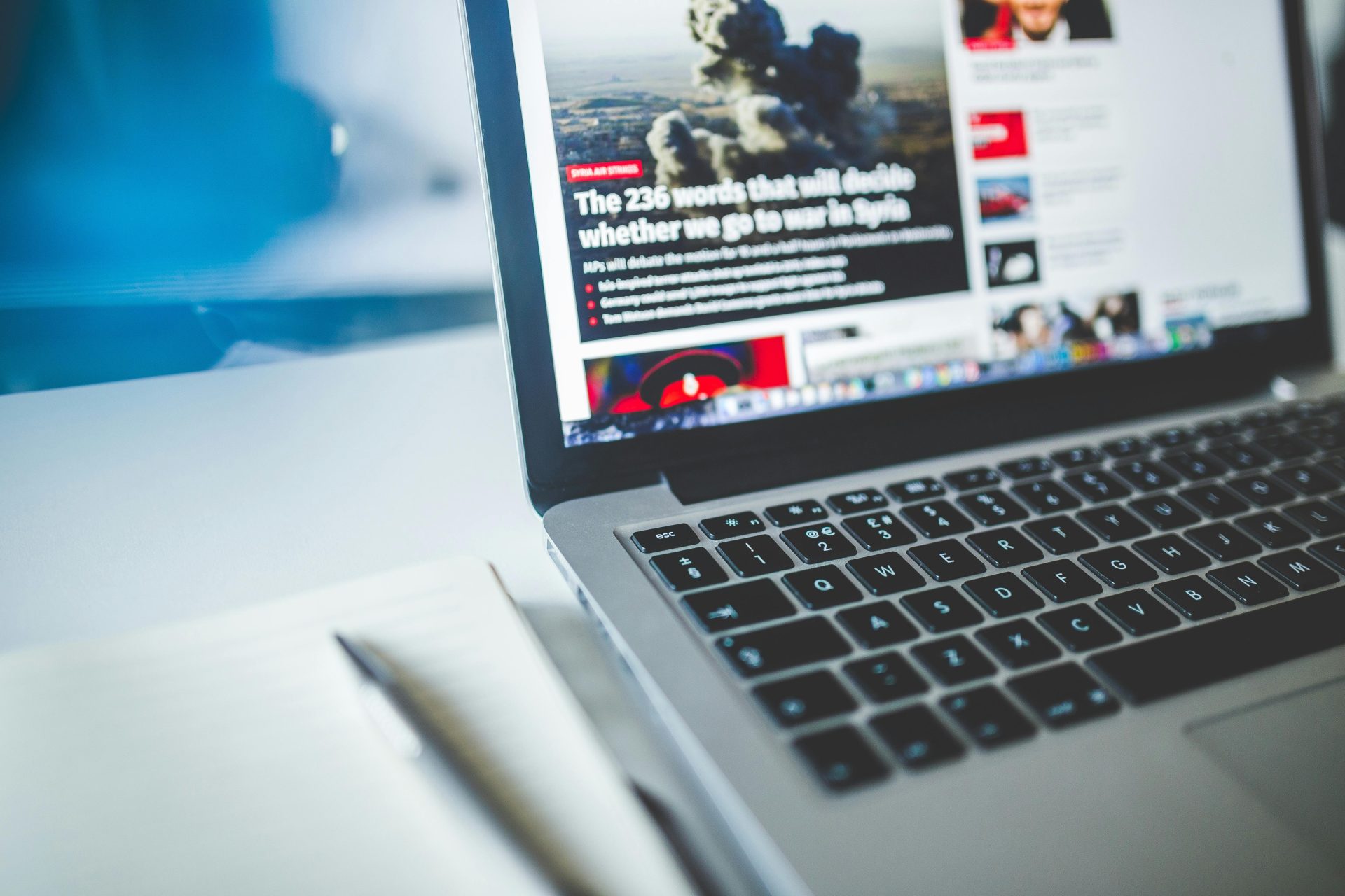 A close-up of a laptop screen displaying a news-style interface, illustrating AI-first website architecture 2026 and how digital content is structured for AI discovery.